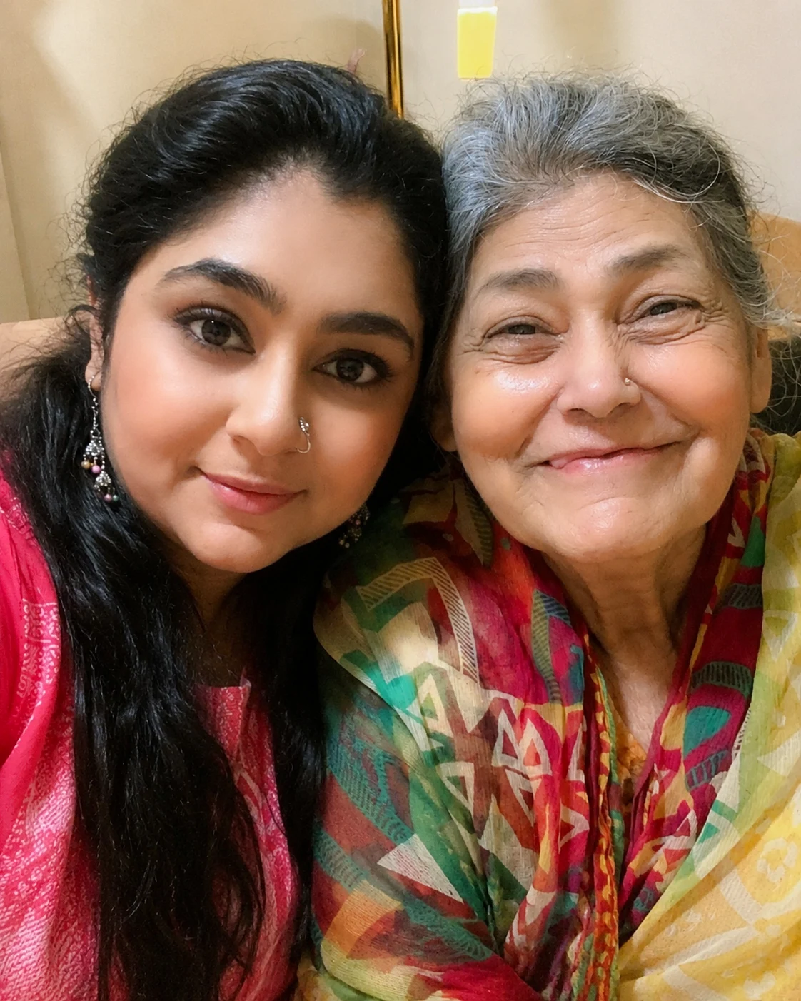 Aysha cheek to cheek with the smiling woman she cared for